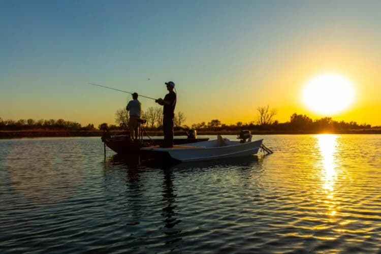 2 people fishing on a boat